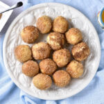 plate seen from top down covered in air fried donut holes.