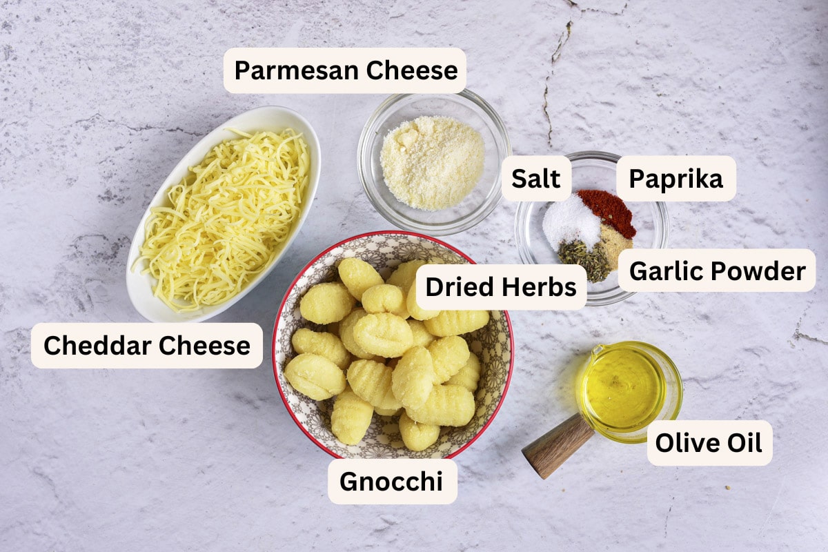 ingredients to make air fryer gnocchi in bowls on counter with labels.