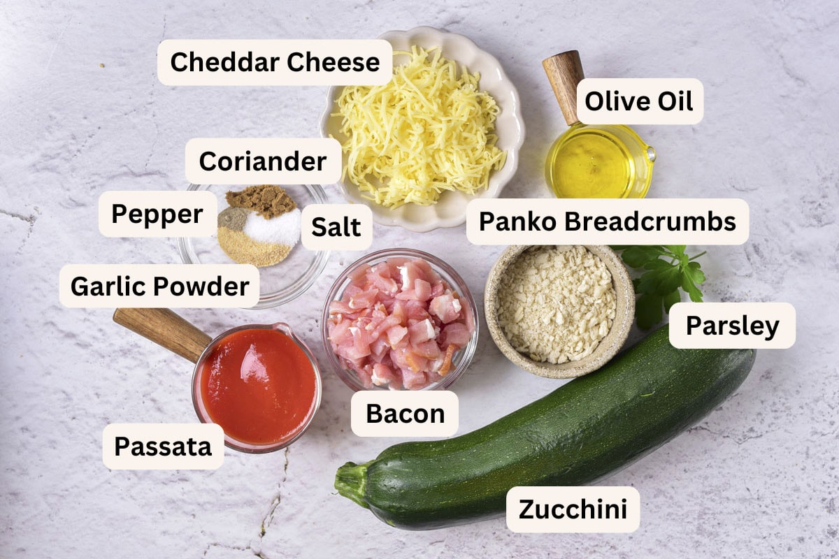 ingredients to make stuffed zucchini on counter with labels.