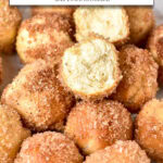 donut holes stacked on plate, one with bite taken out, and text overlay "donut holes in the air fryer".