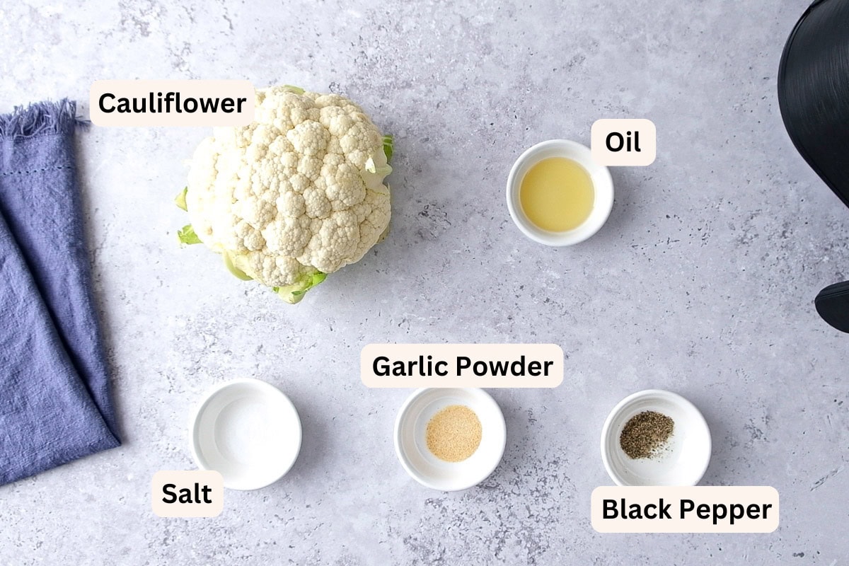 ingredients to make air fried cauliflower on counter with labels.