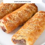 cooked sausage rolls, one with bite taken out, on white plate and text overlay "air fryer sausage rolls".