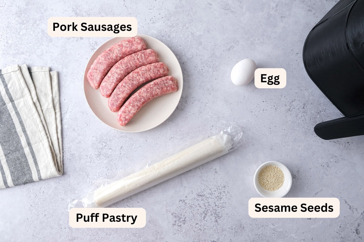 ingredients to make sausage rolls on counter with labels.