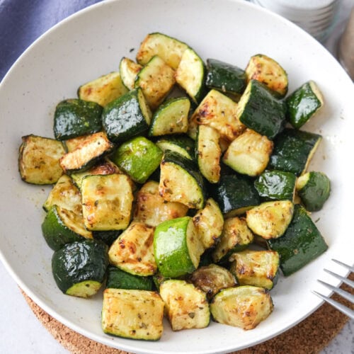 bowl of air fried zucchini pieces sitting on counter.