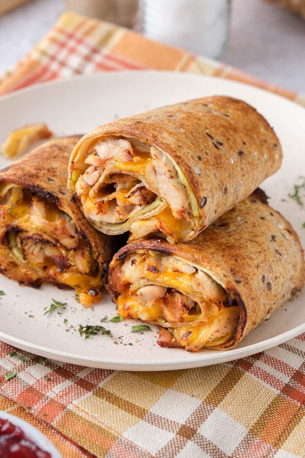 air fryer turkey apple rollups cut in pieces stacked on plate.