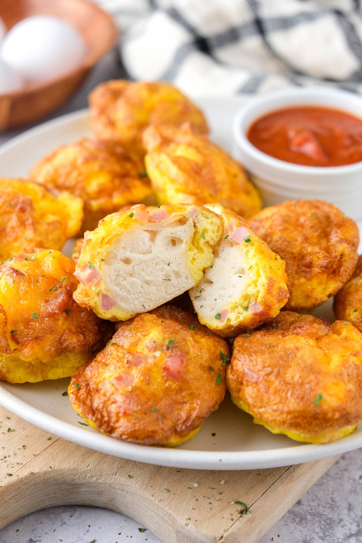 breakfast biscuit and egg bites on plate with ketchup for dipping behind.