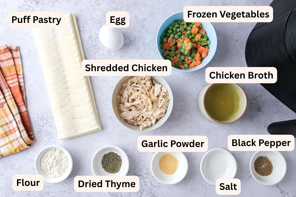 ingredients to make chicken hand pies on counter in bowls with labels.