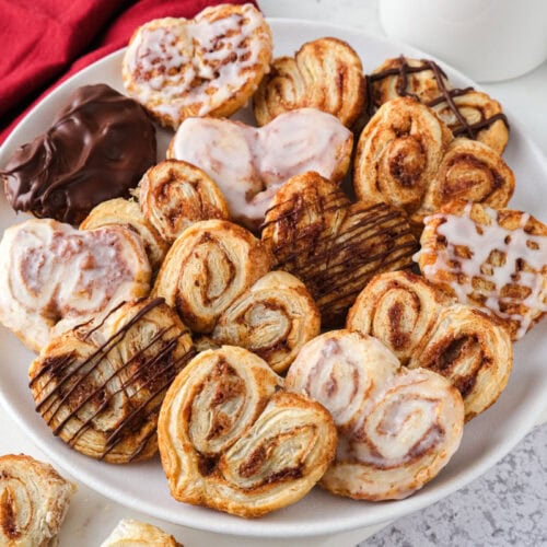 air fryer puff pastry hearts on plate on counter.