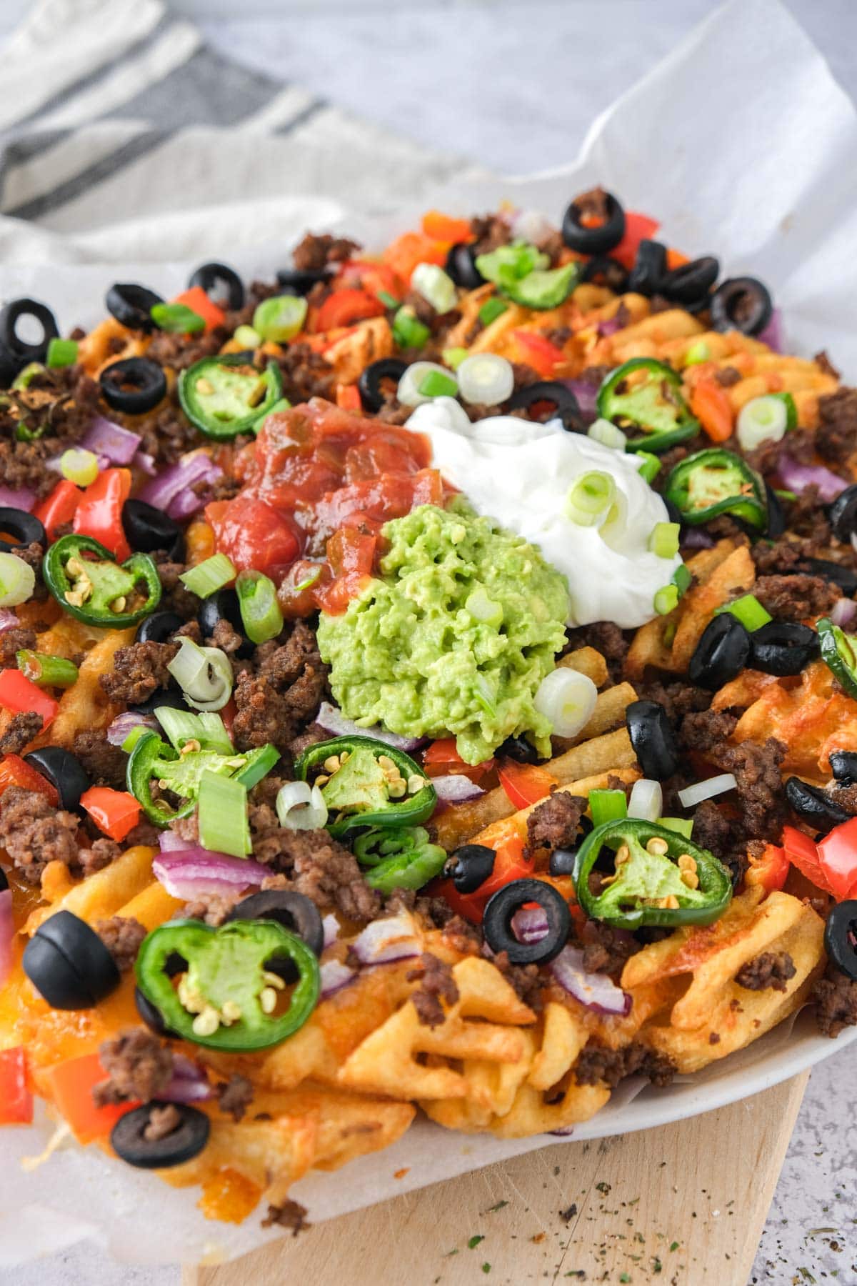 loaded irish nachos topped with sour cream and salsa.