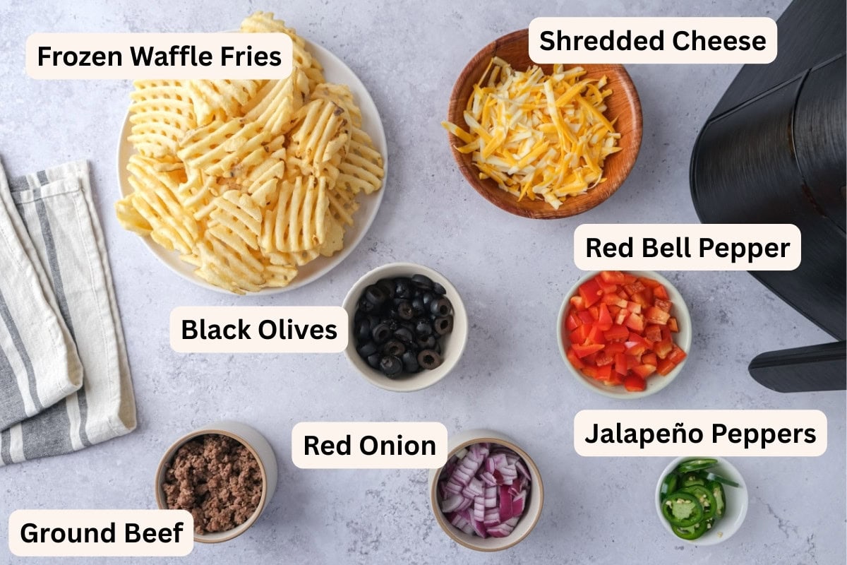 ingredients to make irish nachos on counter in bowls with labels.