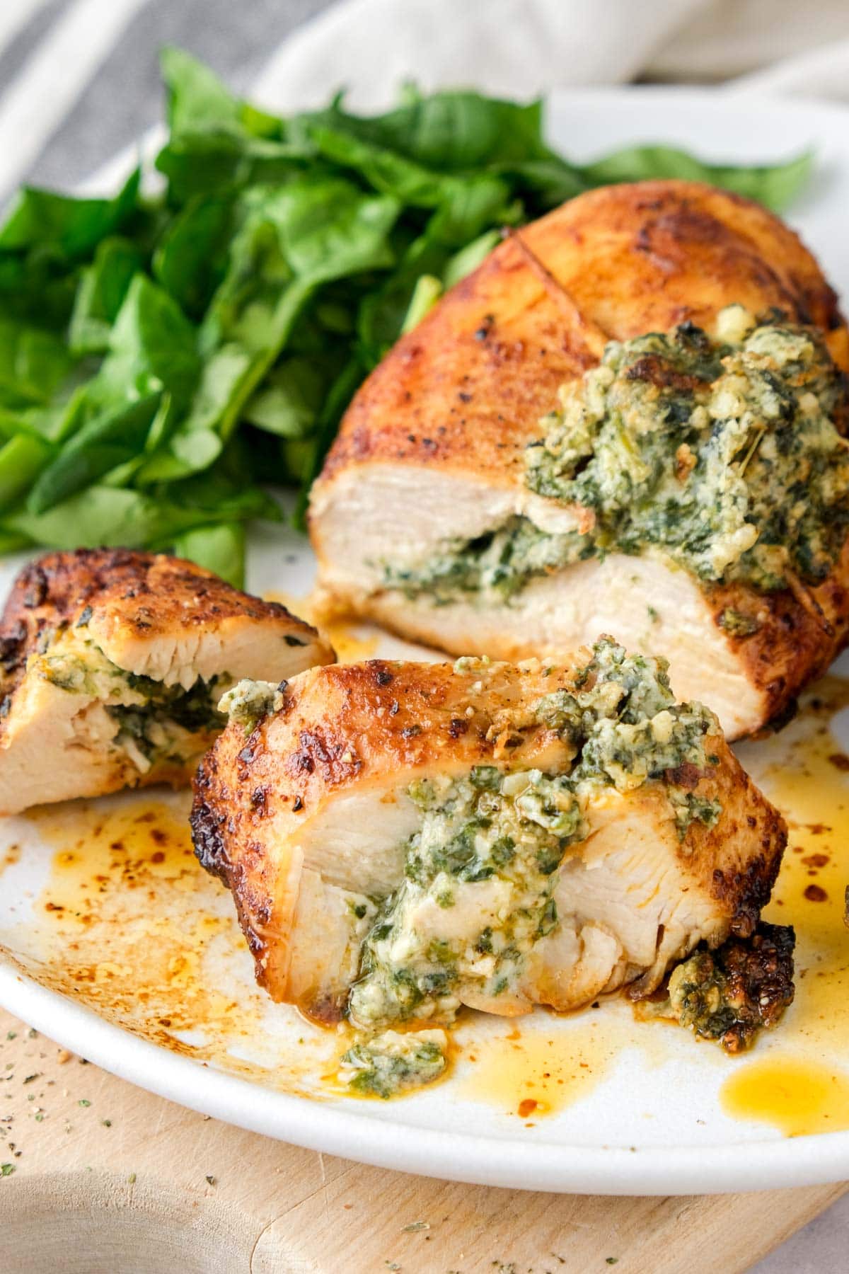 sliced chicken breast on plate stuffed with creamy spinach filling.