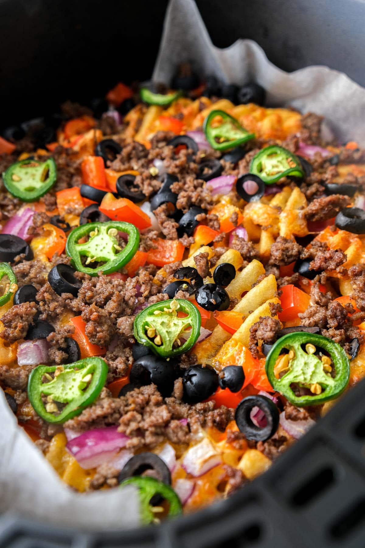 crispy irish nachos in black air fryer basket.