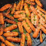 baby carrots covered in parmesan cheese in air basket.