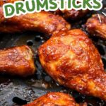 cooked chicken drumsticks with bbq sauce in black air fryer with text overlay "air fryer bbq chicken drumsticks".