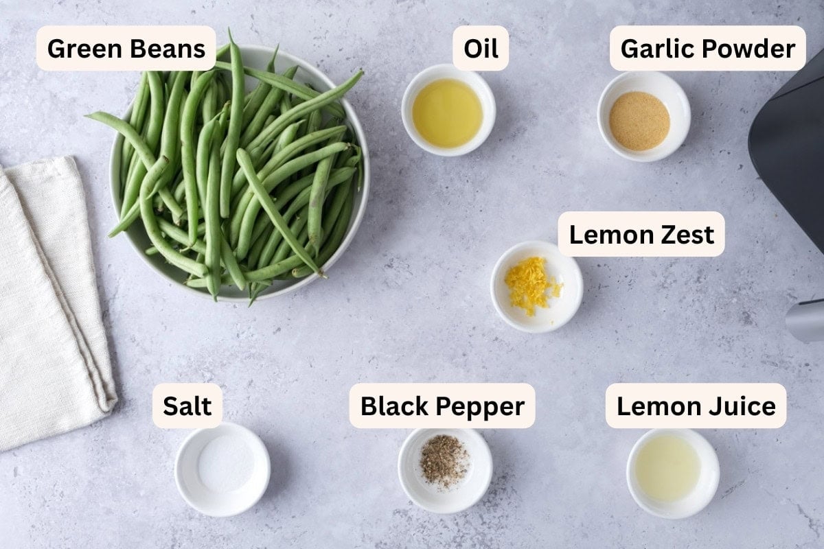 ingredients to make air fryer green beans on counter in bowls.