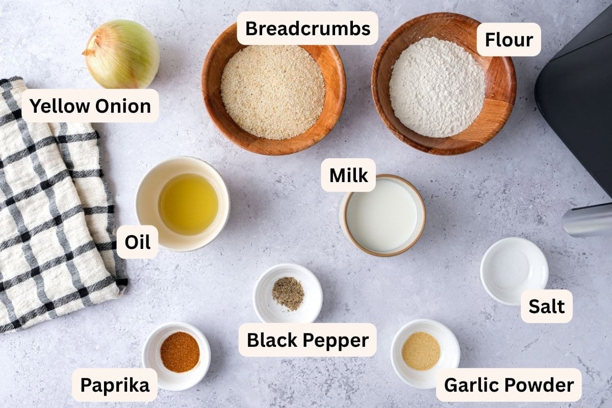ingredients to make onion rings on counter with labels.