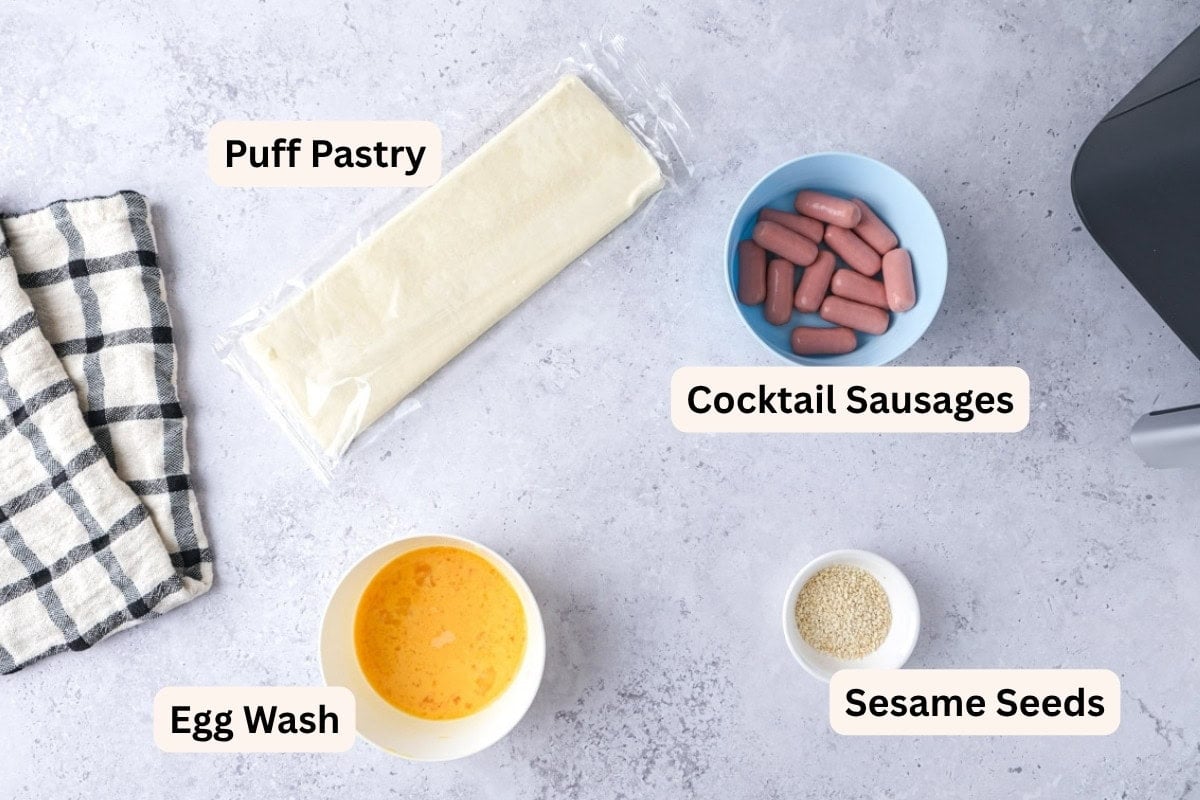 ingredients to make pigs in a blanket on counter in bowls with labels.