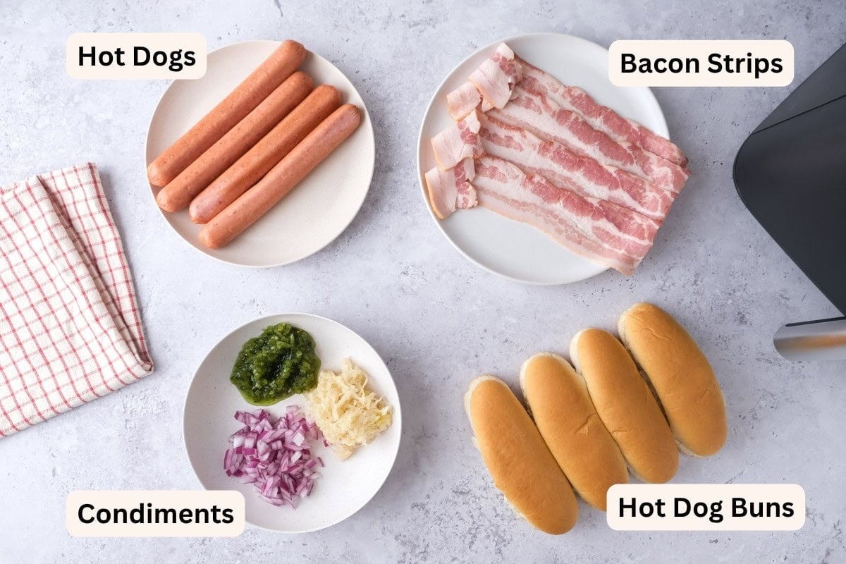 ingredients to make bacon wrapped hot dogs on counter with labels.