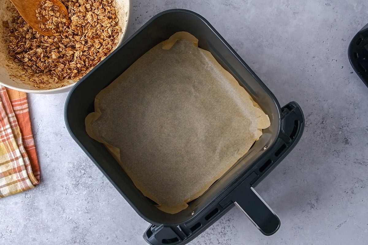 sheet of parchment paper sitting in air fryer basket.